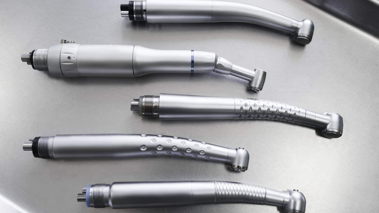 High-speed and electric handpieces on a stainless tray